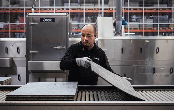 Orak employee sorting carpet tiles