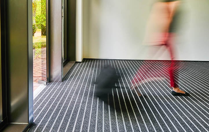 Building's entrance with OBEX Bar flooring shown in CutX Dark Grey 