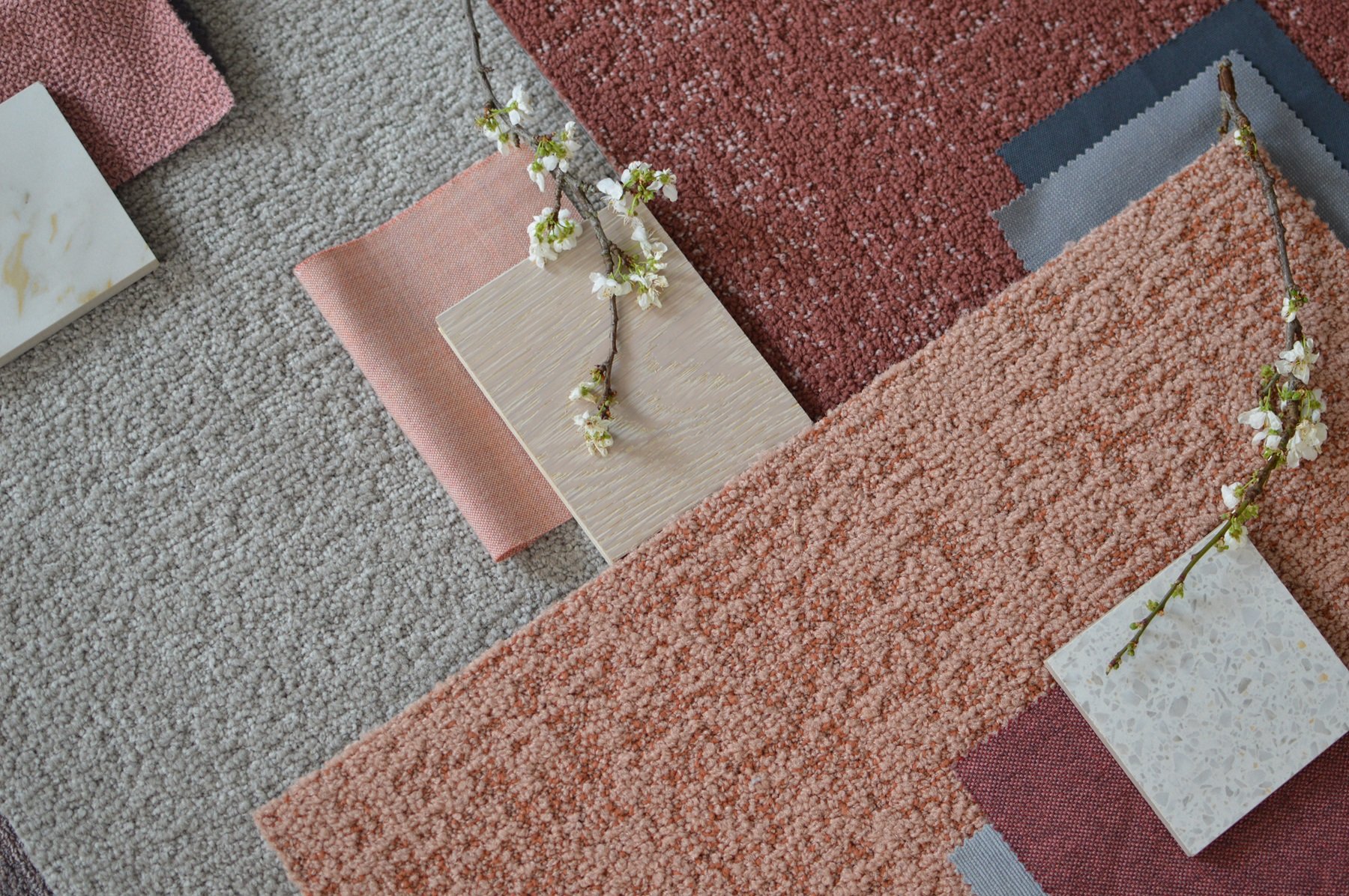Milliken's carpet tiles in warm pinks and grey tones